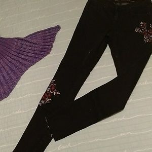 NEVER WORN! Black and floral skinny jeans.